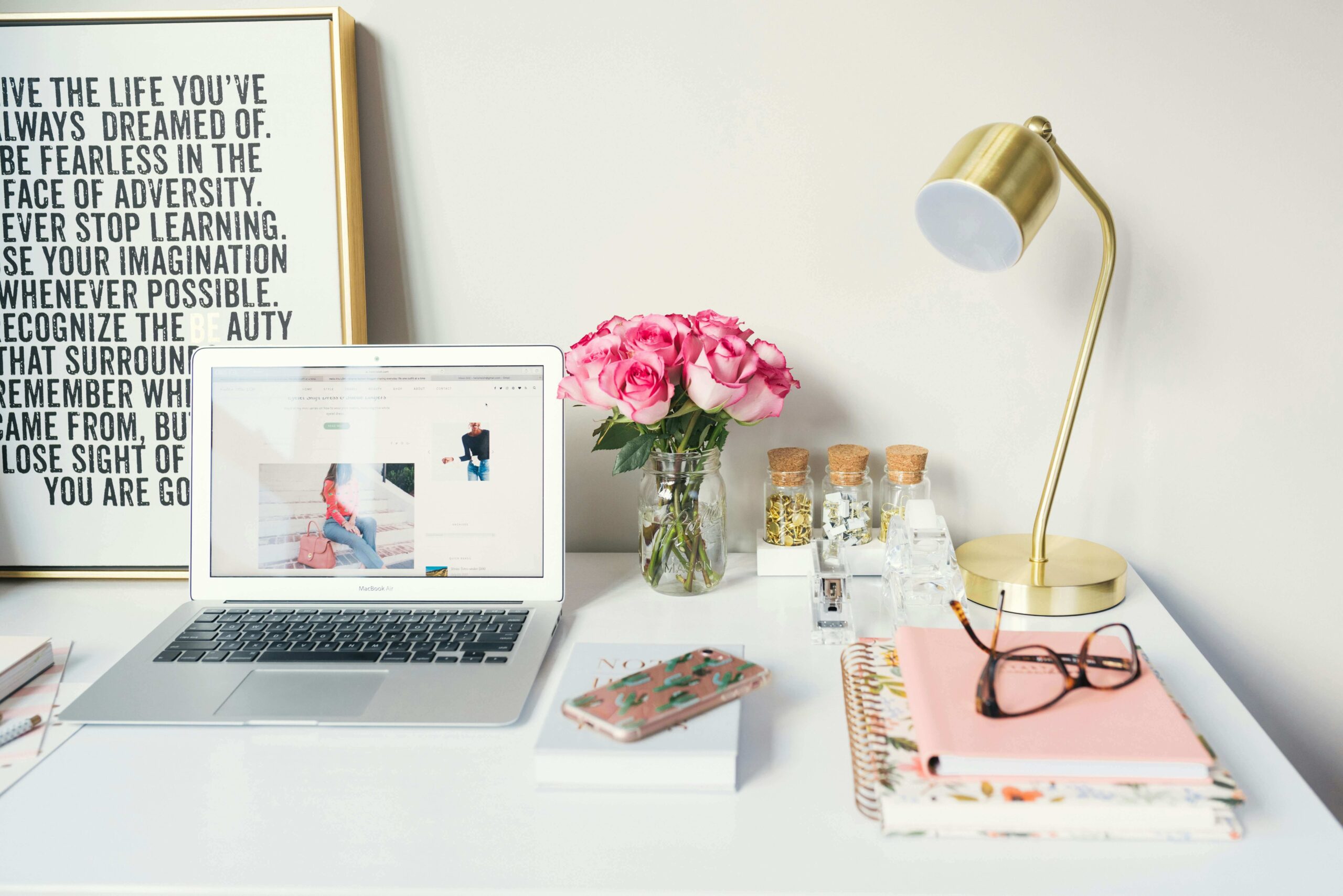 tidy desk with laptop and flowers